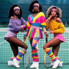 three women in colorful outfits holding tennis racquets