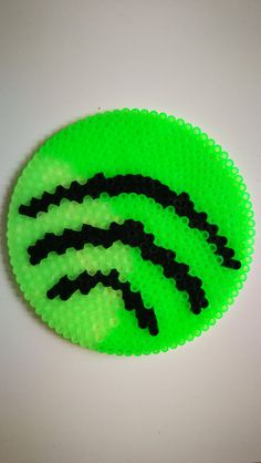 a green and black object sitting on top of a white table