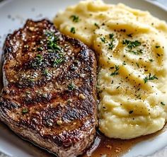 steak, mashed potatoes and gravy on a plate