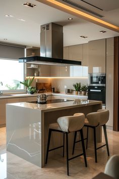 a modern kitchen with an island in the middle and three stools at the counter