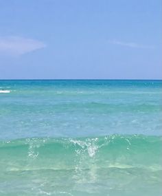 a man riding a surfboard on top of a wave in the ocean