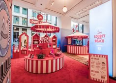 the inside of a store with red and white striped booths