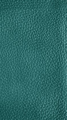 a green leather texture background or wallpaper