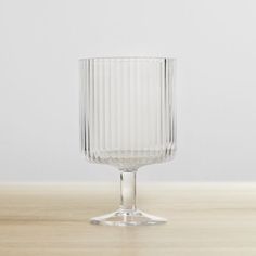 an empty glass sitting on top of a wooden table