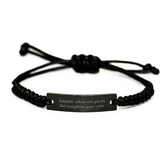 a black bracelet with an inspirational quote on it