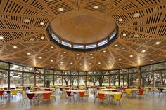 the inside of a large room with tables and chairs in front of a domed ceiling