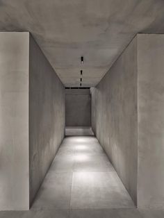 an empty room with concrete walls and floor