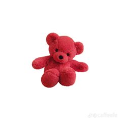 a small red teddy bear sitting up against a white background