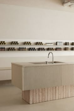 a kitchen with a sink and shelves filled with bottles