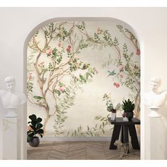 an archway leading into a room with wallpaper and vases on the side table