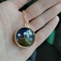 "The unique creative, pure handmade, in-kind shooting, each finished piece may be slightly different, but sufficiently amazing. SIZE & MATERIAL: about 0.2\"*0.6\" resin 3D mushroom, moss, flashing sheet, resin, glass photo frame diameter 1\", copper lid, 18k gold plated chain length 25.6\", lobster clasp. Please try to stay away from water and impact. SHIPPING: Due to extenuating circumstances, my current processing times are between 3-5 business days. Thank you for your understanding." Adjustable Resin Jewelry In Nature-inspired Style, Handmade Magical Charm Necklaces For Gifts, Adjustable Resin Round Pendant Necklace, Gold Resin Nature-inspired Jewelry, Nature-inspired Gold Resin Jewelry, Mushroom Shaped Necklace For Gifts, Handmade Resin Jewelry Nature-inspired, Handmade Magical Round Pendant Necklace, Mushroom Design Necklace Gift