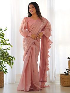 Elevate your style with this stunning peach color organza ruffle saree adorned with fancy lace border work. This ready-to-wear saree comes with a fully stitched blouse material in sizes ranging from XS to XXL, ensuring a perfect fit for any occasion. The designer saree is perfect for parties and receptions, allowing you to make a fashion statement with its trendy lace detailing. Crafted with high-quality organza material, this saree offers a luxurious feel and elegant look. Lehenga Crop Top, Lehenga Choli Wedding, Party Wear Lehenga Choli, Reception Gown, Bollywood Lehenga, Ruffle Saree, Readymade Saree, Ready To Wear Saree, Organza Sarees