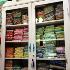 a display case filled with lots of colorful fabrics