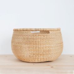 a woven basket sitting on top of a wooden table