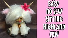 a white stuffed animal with horns and a bow on it's head, sitting next to a pink sign that says easy no sew sitting highland cow