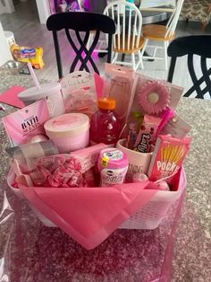 a pink basket filled with lots of different items