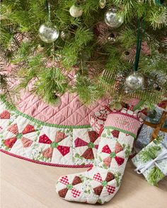 a quilted christmas stocking hanging from a tree