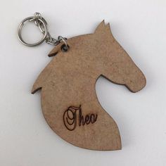 a wooden keychain with the word aha on it and a horse head