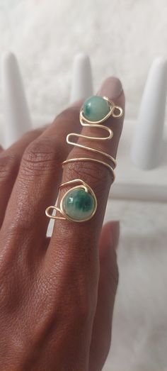 This beautiful wire wrapped ring is adorned with beautiful green jade beads. The ring sits comfortable on the find and can be easily adjusted to be tighter or looser on the finger. The wire used is a beautiful gold tarnish resistant craft wire. Ring Sizing: If you need help figuring out your ring size - contact us as we can provide you with a printable ring sizing packet with diy instructions. Care Instructions: Avoid leaving ring in moist or damp places. Remove during hand washing. Do not overs Wire Rings Ideas, Diy Wire Wrapped Rings, Wire Rings Tutorial, Diy Wire Rings, Wired Jewelry, Ring Tutorial, Wire Wrapped Ring, Wire Ring, Wire Rings