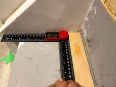 a person measuring the height of a piece of wood