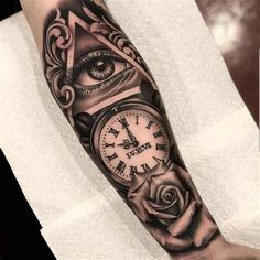 a man's arm with an all seeing clock and rose tattoo design on it