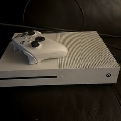 a white video game console sitting on top of a table