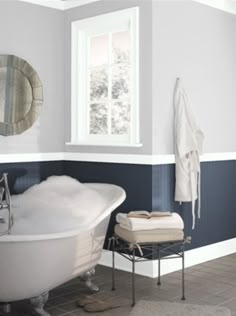 a white bath tub sitting next to a window