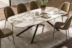 a marble dining table with six chairs around it