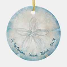 a blue ornament with a white flower on it