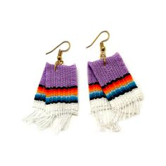 two pairs of purple and white earrings with fringes on the ends, hanging from gold hooks