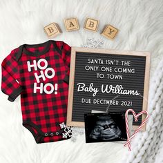 a baby's first christmas outfit and other items are laid out on a blanket