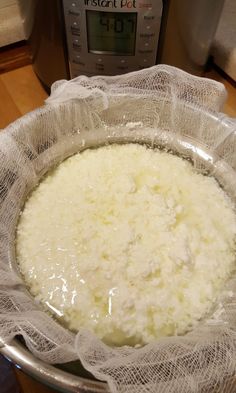 rice in a mesh bowl with an instant pot pressure cooker in the back ground