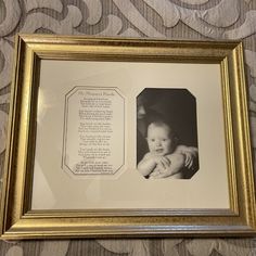 a gold framed photo with a baby's handwritten poem in the center and an image of a man holding a baby