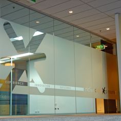 the entrance to an office building with glass walls