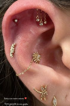 an ear with three different piercings attached to it's side, and two smaller ones