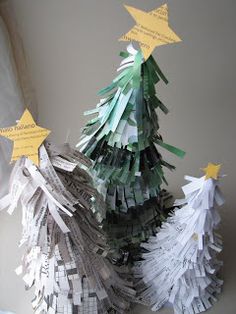 a christmas tree made out of newspaper strips and paper stars is shown in front of a white wall