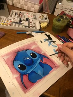 someone is painting an image with watercolors on paper