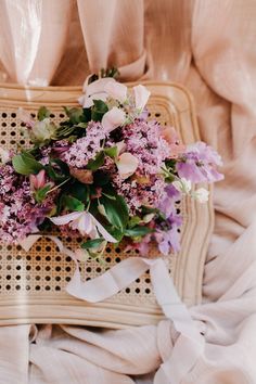 a bouquet of flowers sitting on top of a wicker chair