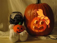 two pumpkins with faces carved into them sitting next to each other on a table