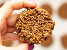 a close up of a person holding a cookie