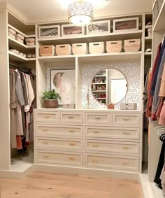 an organized closet with white drawers and gold handles