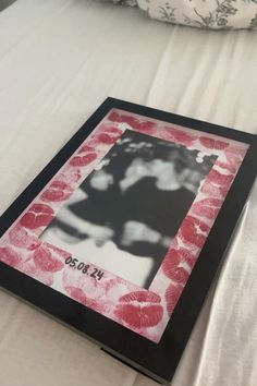 a photo frame sitting on top of a bed