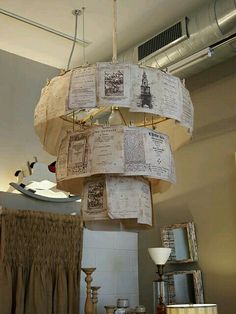 a chandelier made out of old newspapers hanging from the ceiling