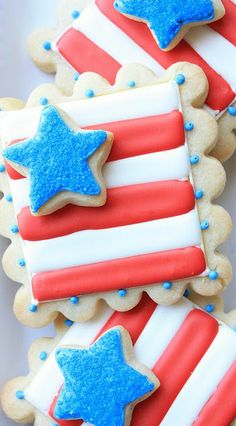 patriotic cookies with red, white and blue icing on them are arranged in the shape of an american flag