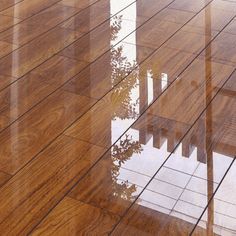 a wooden floor that has been cleaned and is reflecting in the wet water on it