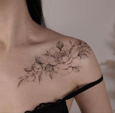 a woman with a flower tattoo on her chest