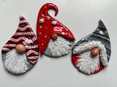 three christmas ornaments are sitting on a table