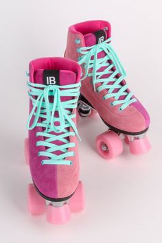 two pink roller skates with blue laces on them