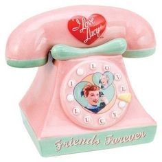 an old fashioned pink phone with a heart on the dial and words friends forever written on it