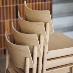 four wooden chairs stacked on top of each other